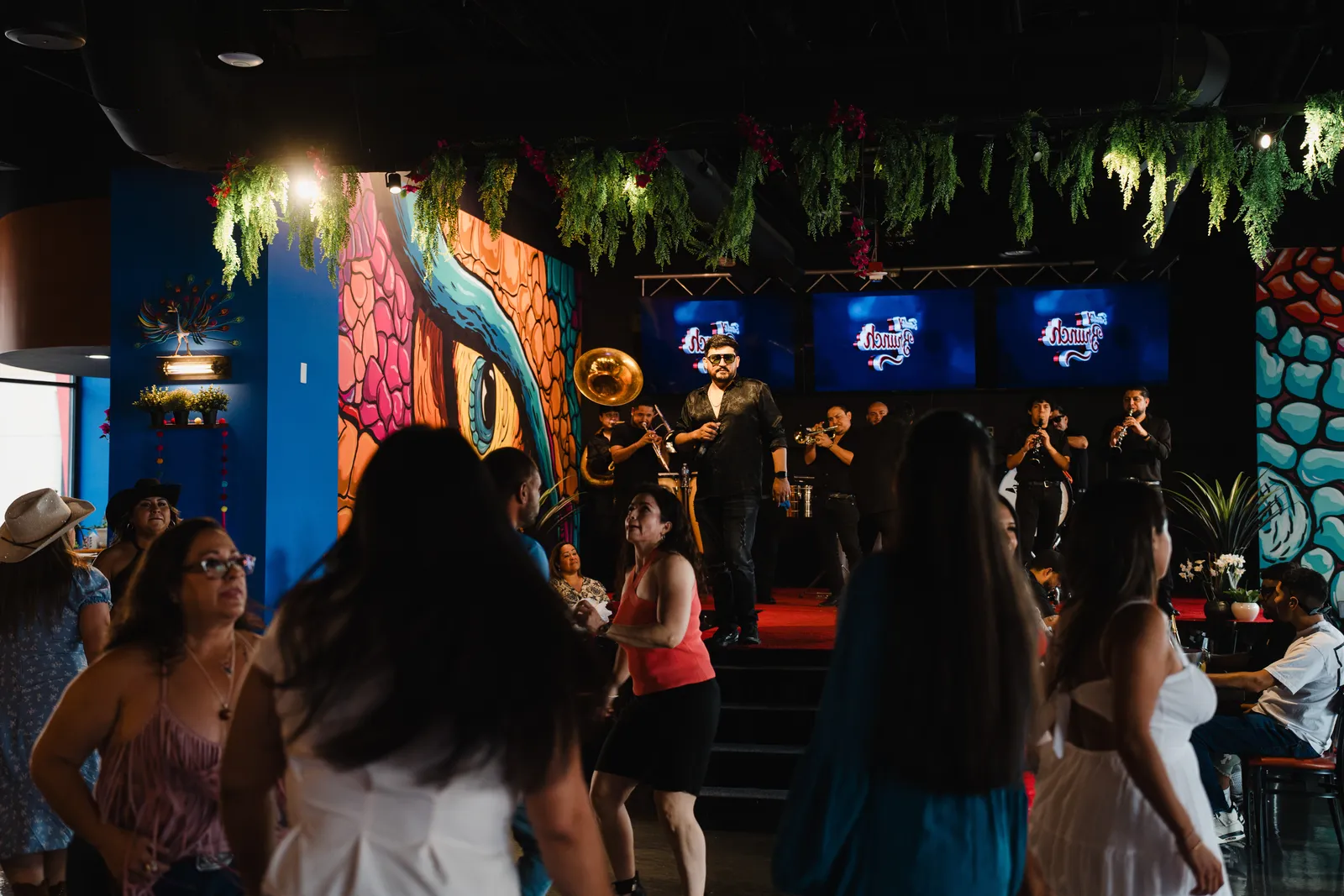 Banda performing with tuba inside Alebrijes