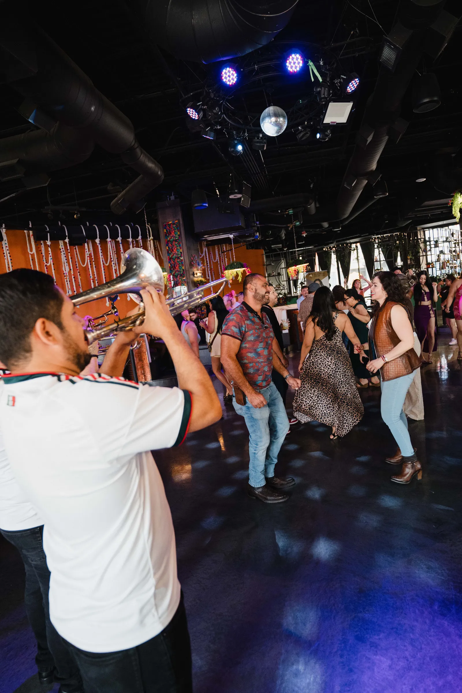 Trumpet player with guests dancing